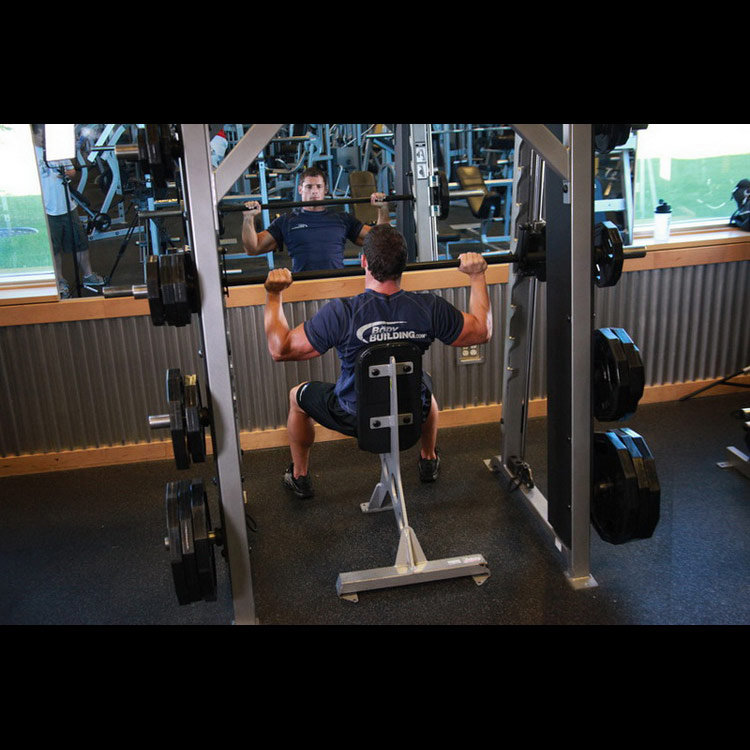 техника выполнения упражнения: Жим штанги сидя в машине Смита (Smith Machine Overhead Shoulder Press) на фото